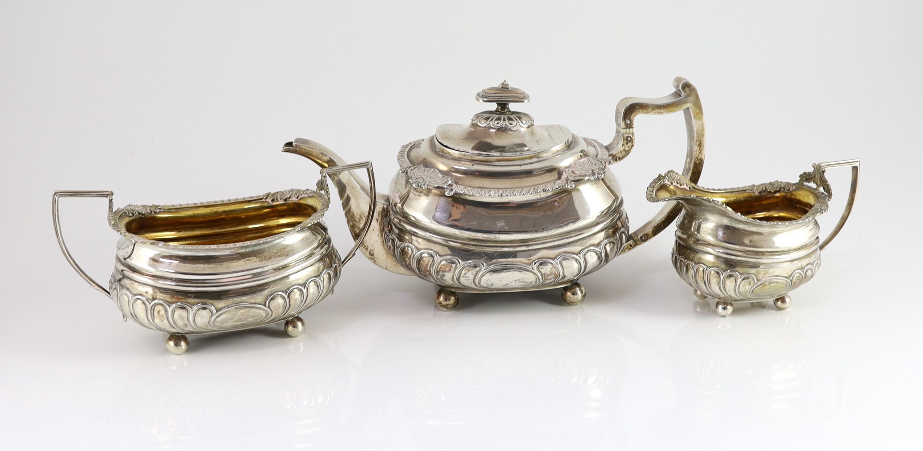 A George III Scottish silver demi-fluted three piece tea set by George Fenwick